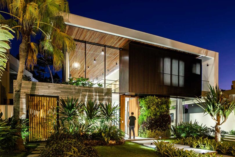 angled evening view of the front facade of modern home