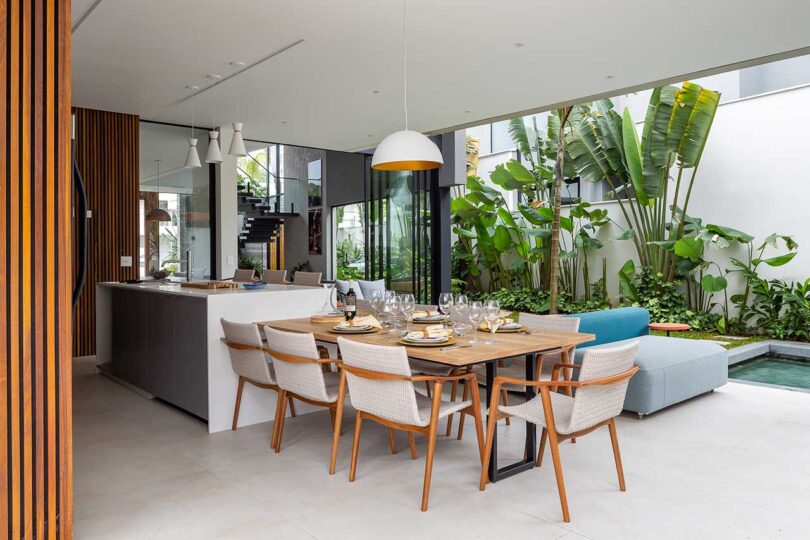 covered patio view of modern house with outdoor kitchen, eating and seating areas