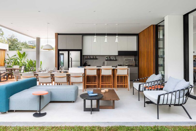 covered patio view of modern house with outdoor kitchen, eating and seating areas