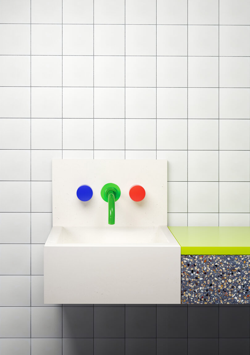 small white sink with green faucet and blue and red faucet handles