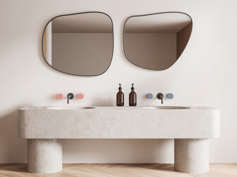 double vanity with two sinks featuring light pink and light blue faucet handles and two mirrors