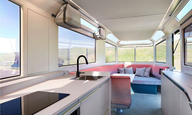 Interior render of Lightspeed L1 trailer showing seating, surfaces, and wraparound windows.