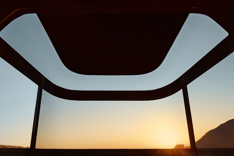 Glass windows and skylights of L1 trailer with sunset sunlight visible in the background.