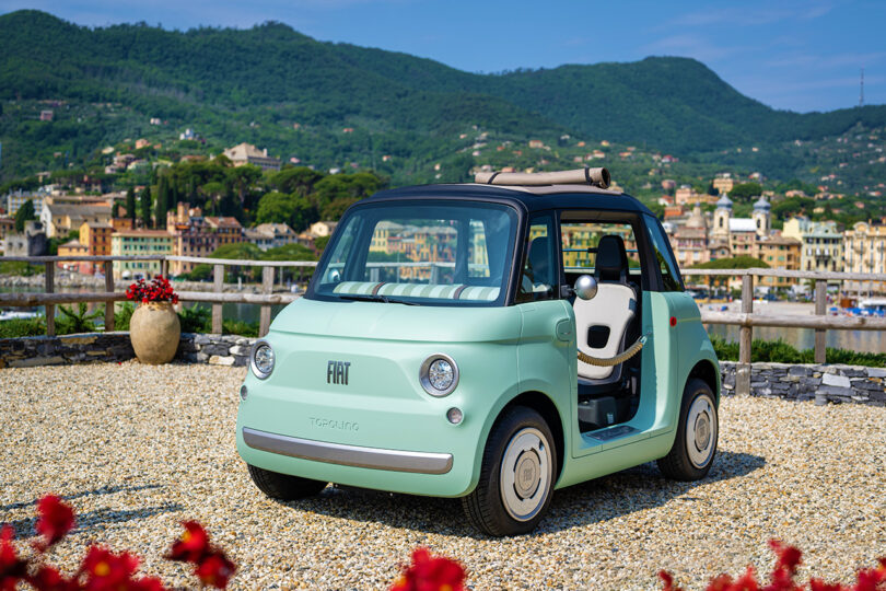 angled view of mini mint-colored car with black roof