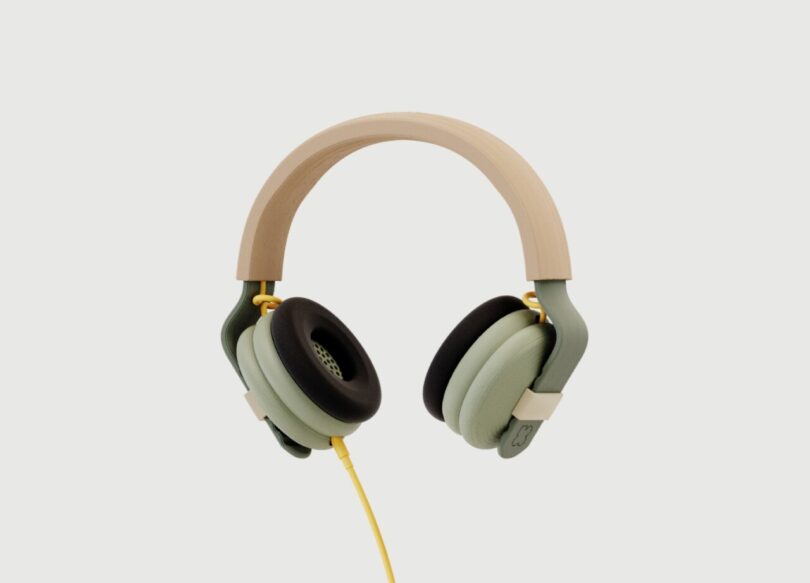Kibu headphones with light green ear cups and light tan head band with yellow headphone cable.