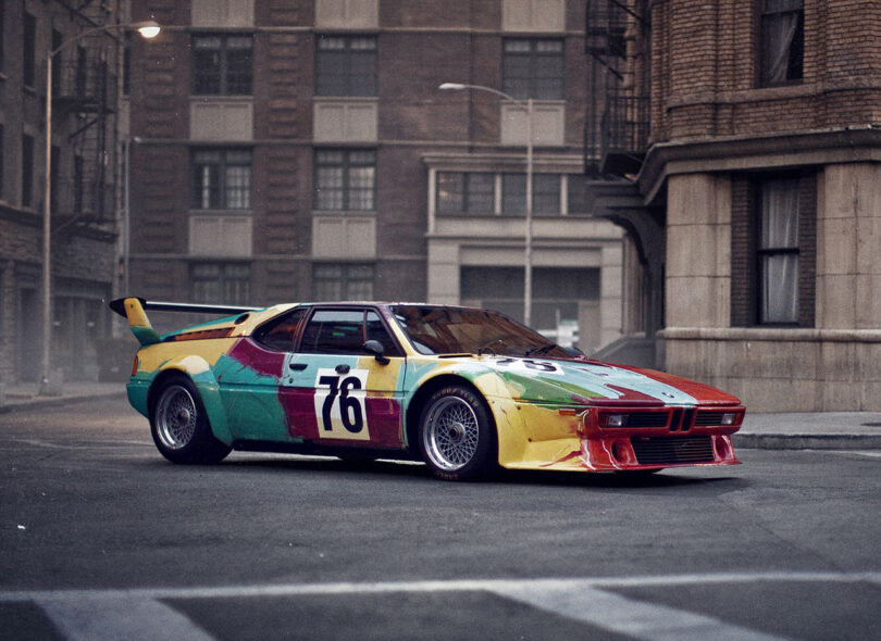 Andy Warhol's 1979 BMW Art Car parked in a city setting.