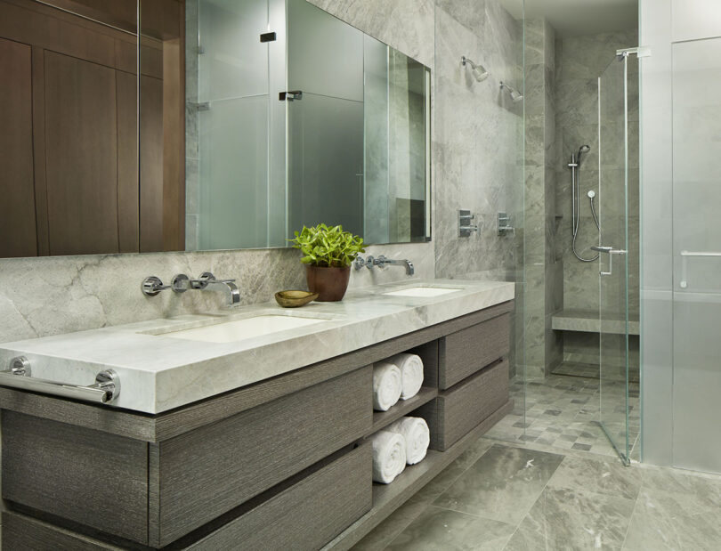 modern styled bathroom with floating double vanity and walk-in glass shower
