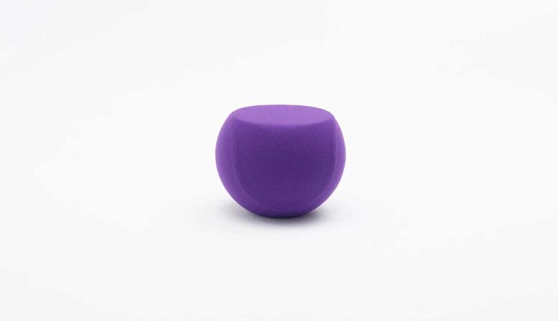 circular purple side table on a white background