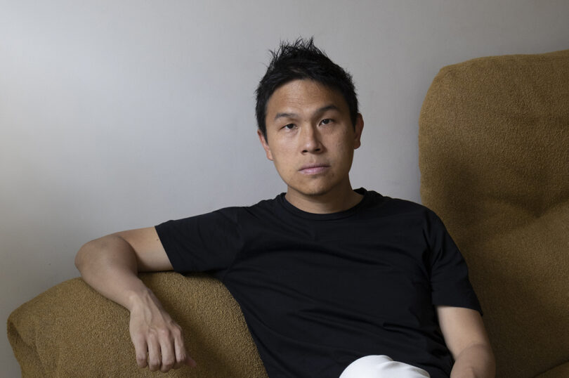 brown-skinned man with short black hair wearing a black t-shirt