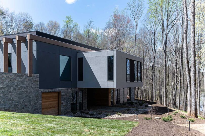 angled exterior view of modern grey house with cantilevered rooms