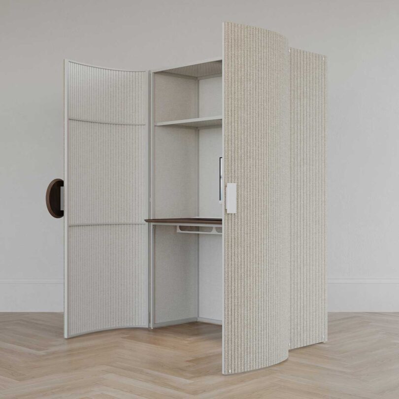 angled shot of oatmeal colored cabinet with open doors revealing a desk inside