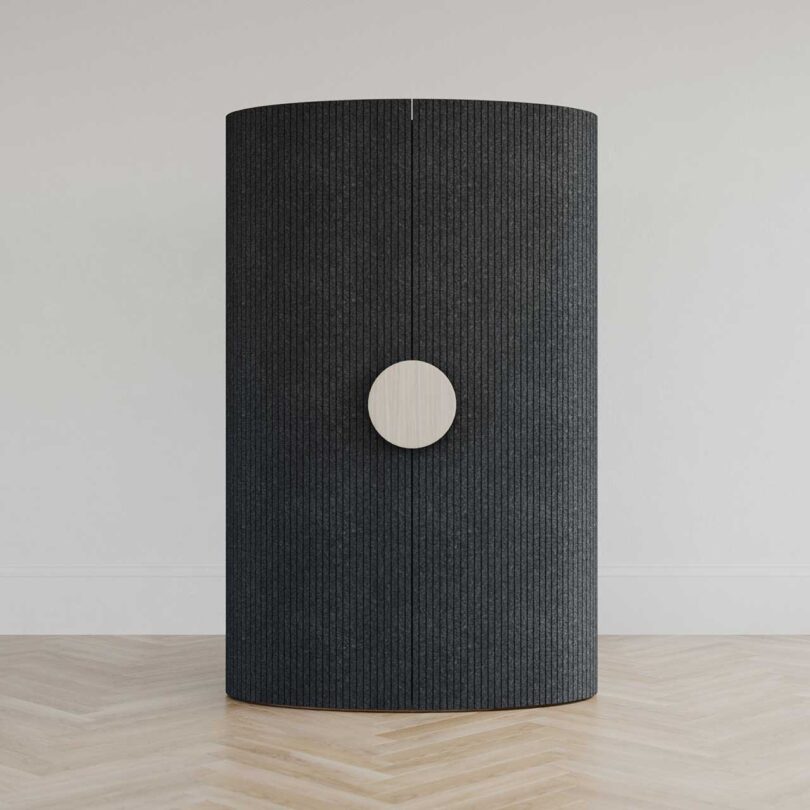 close black cabinet with white disc handle on front