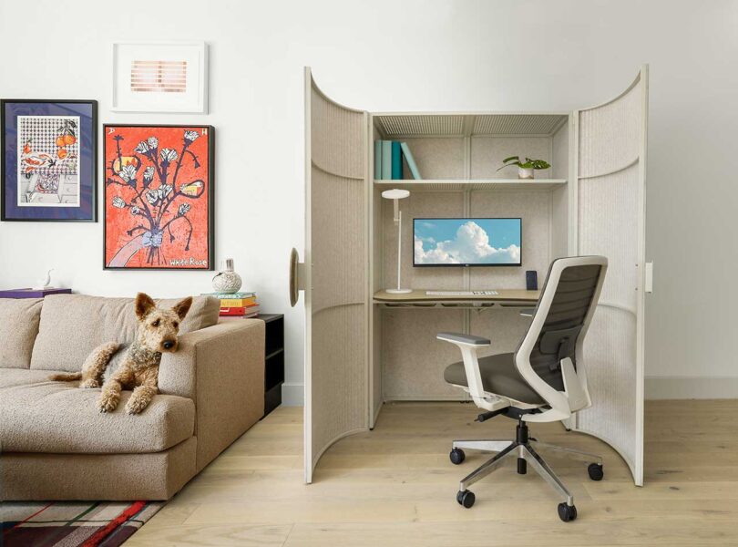 a open cabinet in a modern living space that houses a home office setup