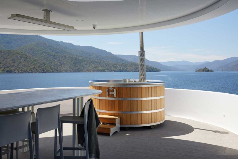 top deck view of partially covered space with bar and hot tub