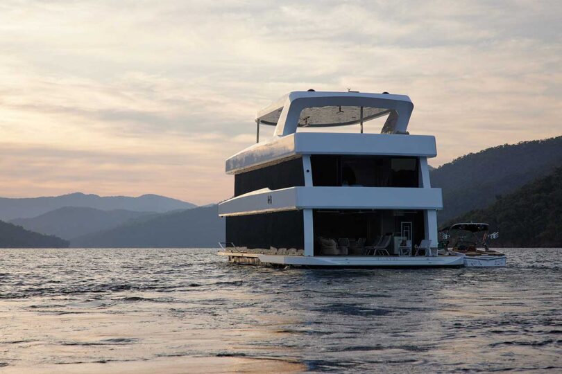 partial back view of modern houseboat floating on lake