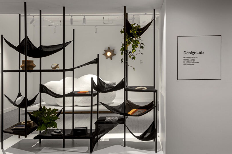 white showroom with plaque reading DesignLab and textile shelving