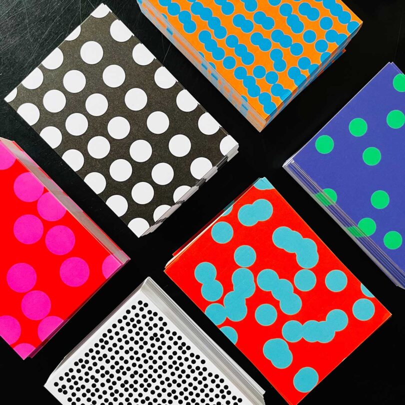 six colorful, patterned boxes on a black background