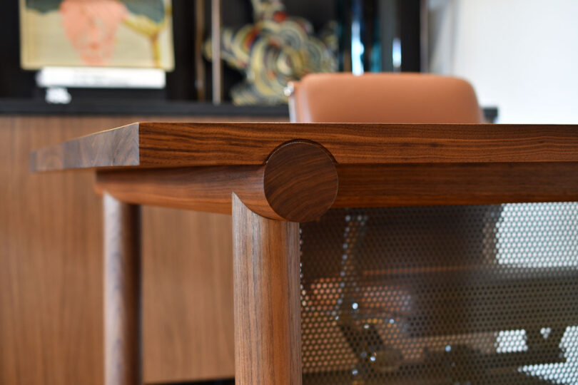 detail of walnut desk and office chair
