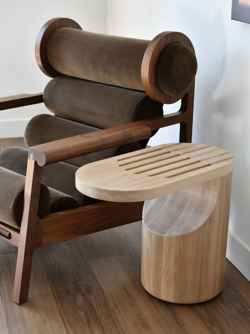 dark wood and dark brown upholstered armchair and ottoman with light wood side table