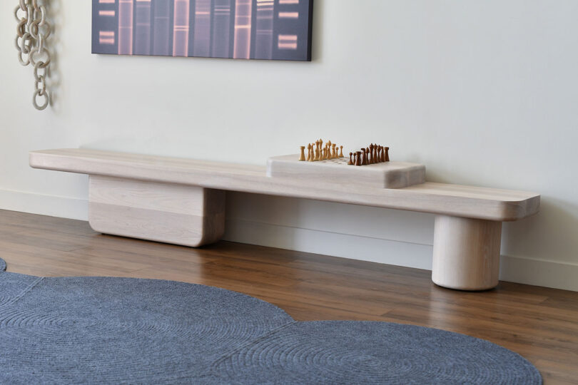 long light wood bench with built-in chess board