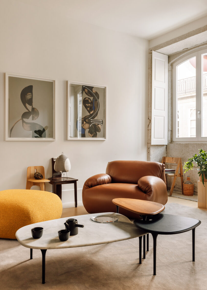 styled interior space with brown leather modular chair and nesting tables