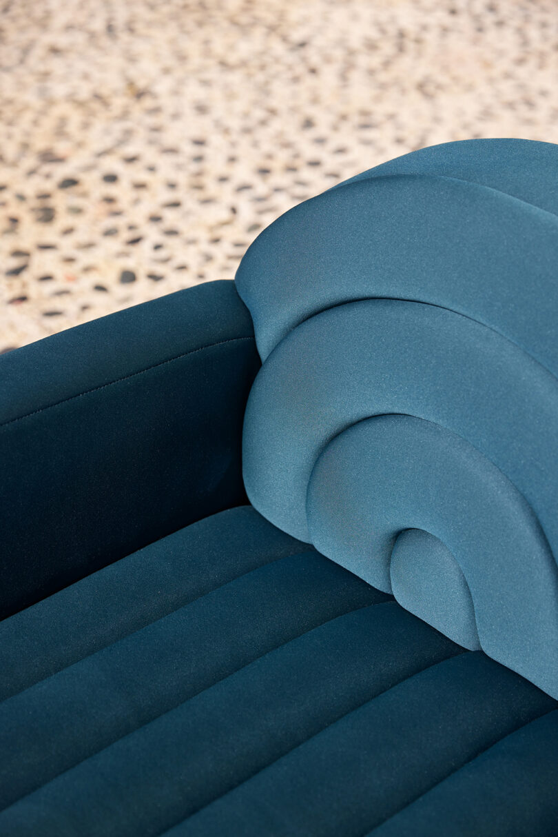 detail of blue outdoor channel tufted sofa