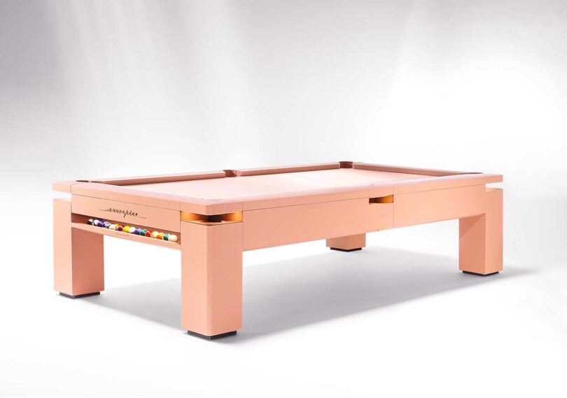 angled set view of pale pink modern pool table