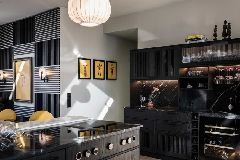 angled view of modern kitchen with black cabinets