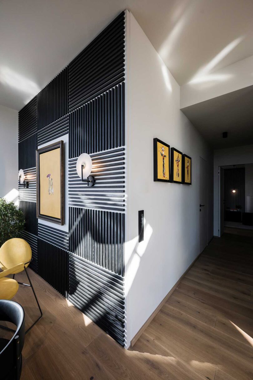 angled view of modern apartment with feature wall made up of black slats alternating for linear pattern