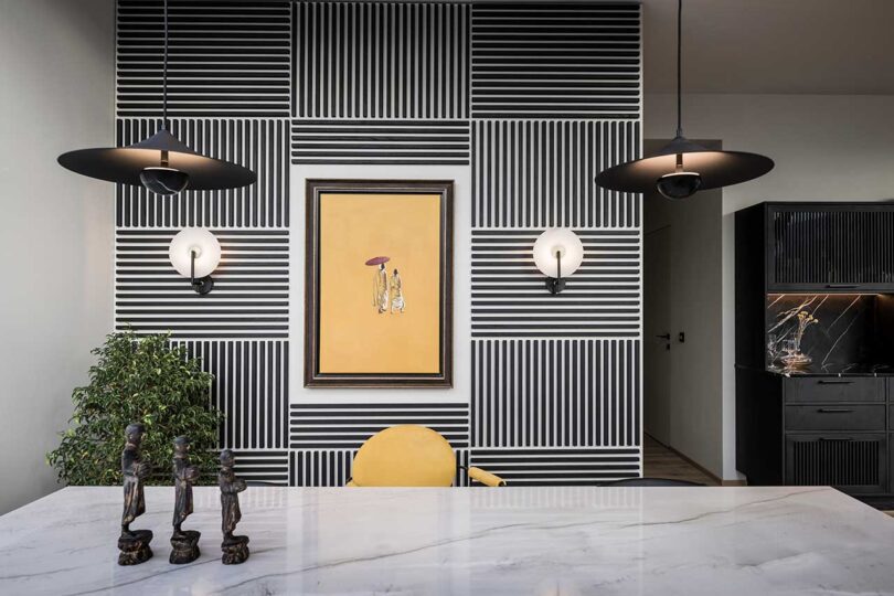 view of modern apartment with feature wall made up of black slats alternating for linear pattern