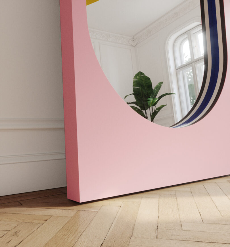 detail of large floor mirror within a light pink frame