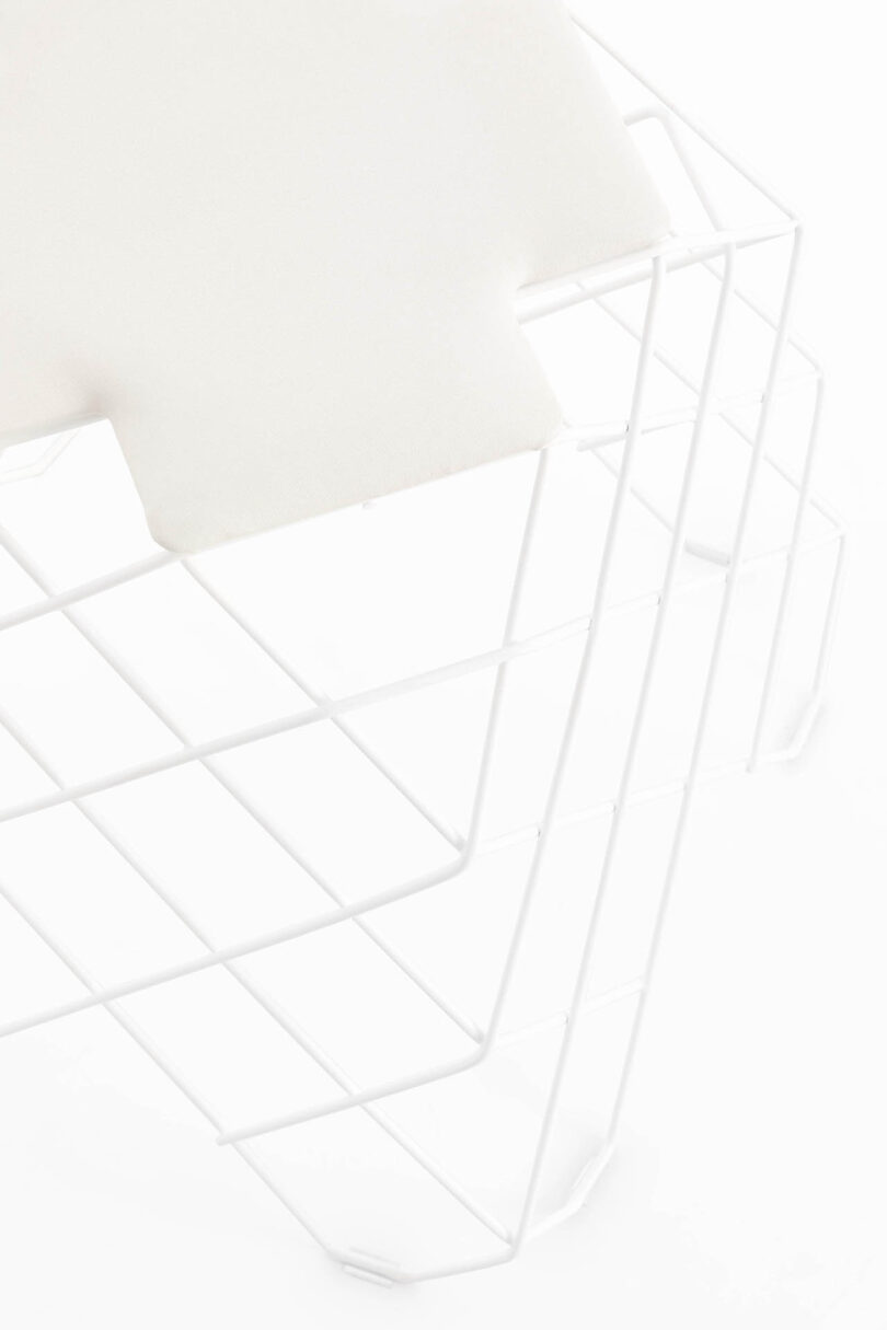 detail of wire work stool/table on white background