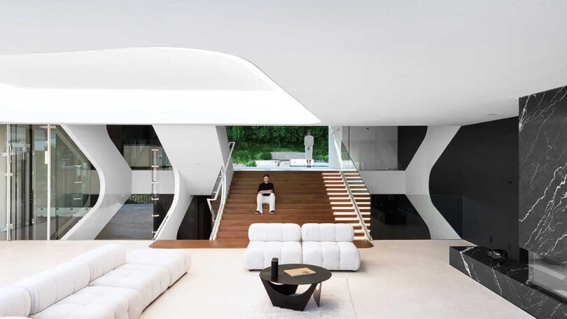 interior view of modern futuristic living room with large white modular sofa