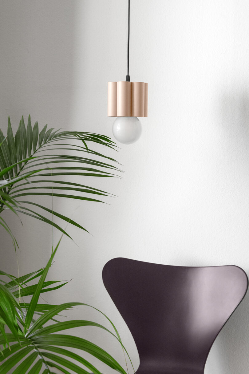 fluted light pink pendant lamp in a styled living space