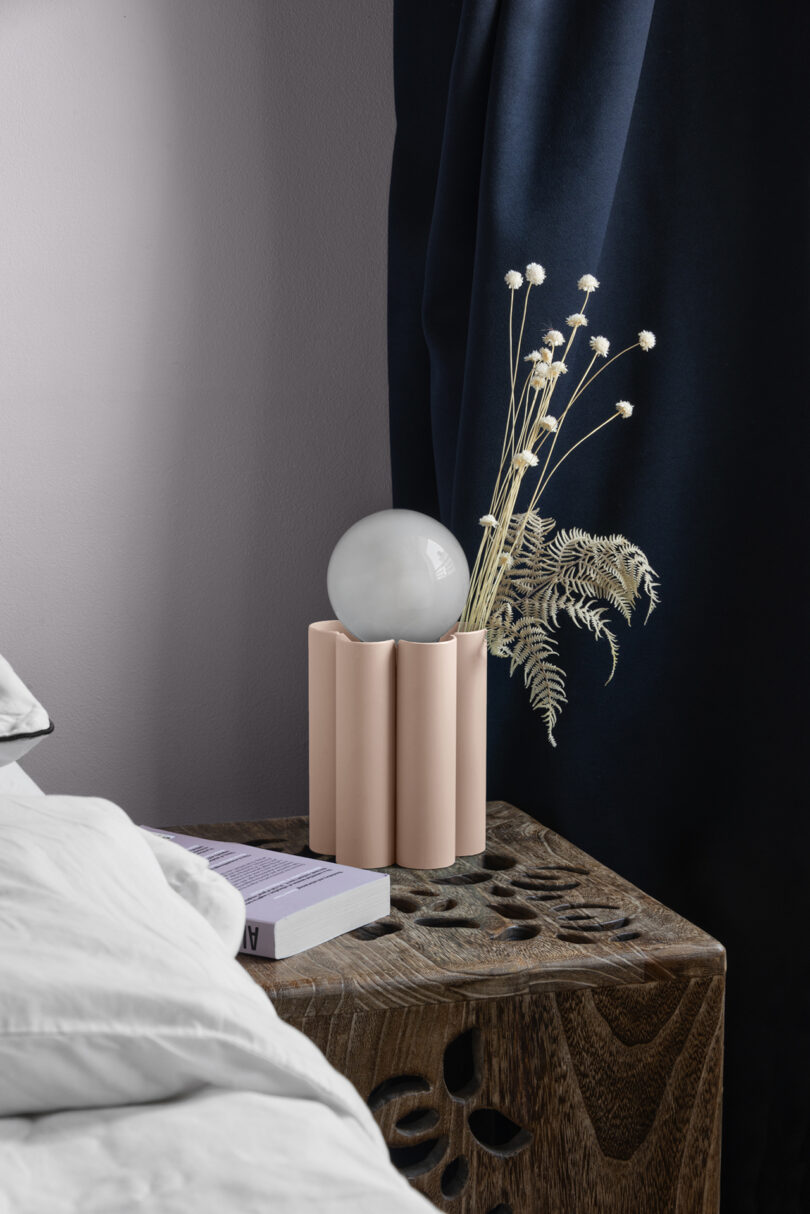 fluted light pink table lamp in a styled living space