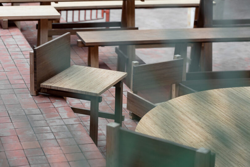 outdoor area with various integrated forms of wood tables and seating