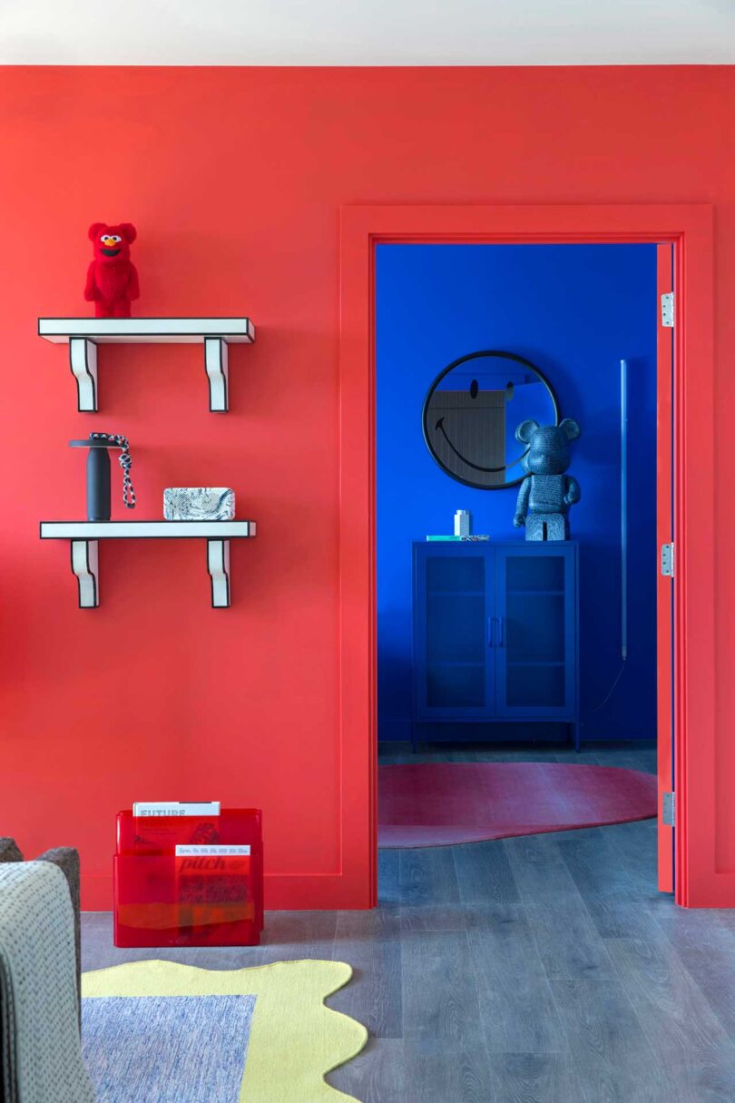 interior view looking past red wall into cobalt blue bedroom