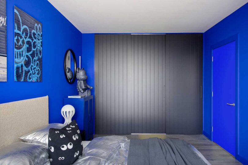 view of modern bed in bright blue bedroom