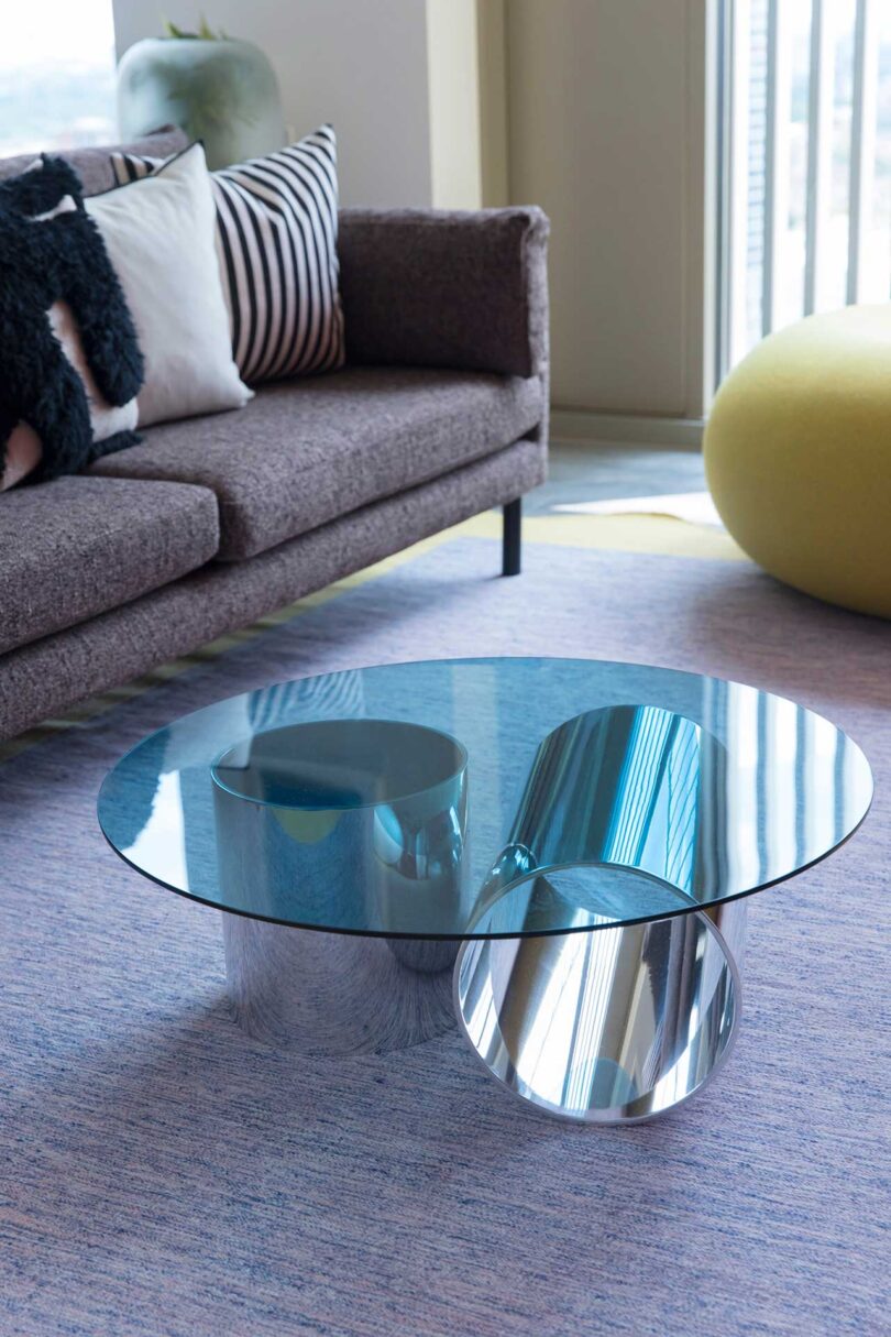 angled down interior view of modern glass coffee table with blue glass top