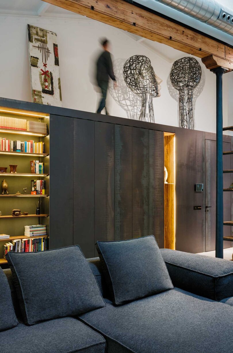 angled interior shot of partial modular sofa with metal storage and art on top