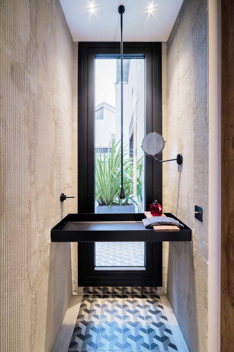 narrow modern bathroom with sink floating in front of long vertical window