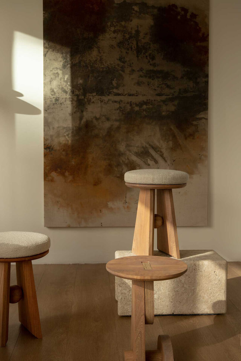 three wood stools in a styled interior space