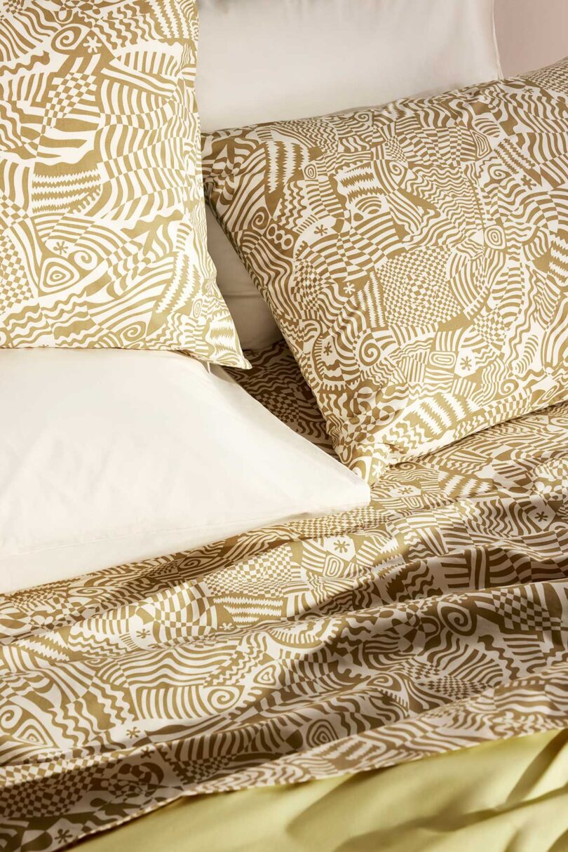 cropped down view of golden yellow and white patterned bedding