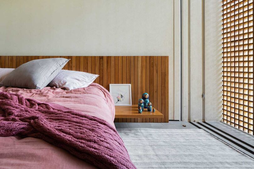 partial view of modern bedroom with pink bedding