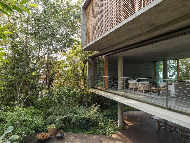 angled view of elevated rectangular modern house elevated in forest