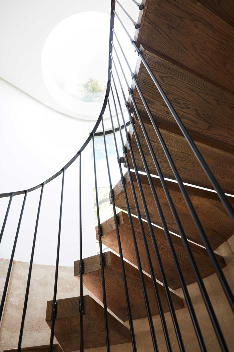 interior shot of curved staircase with skylight above