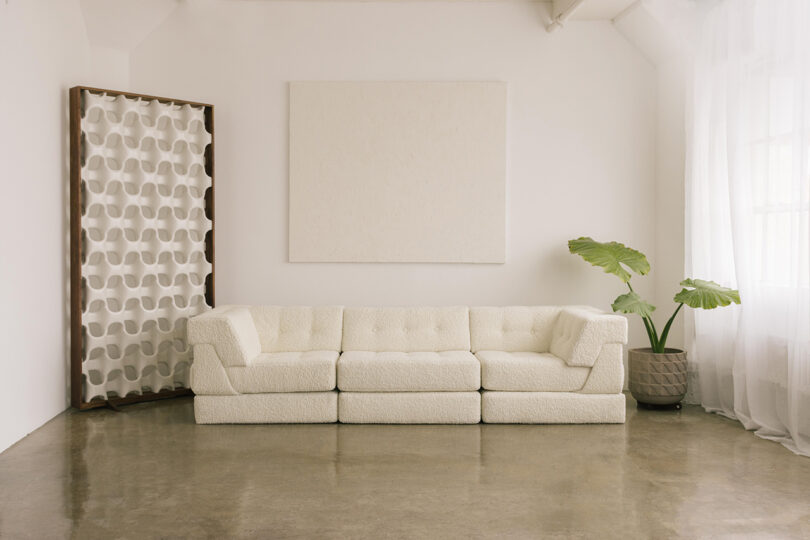 three-seater double layer white sofa in a styled interior space