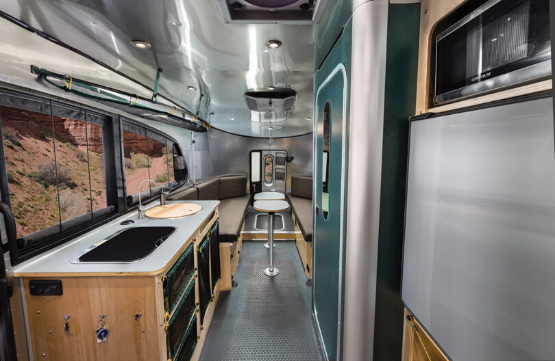 View from kitchen galley area toward the rear seating and sleep quarters of the REI edition Airstream trailer.
