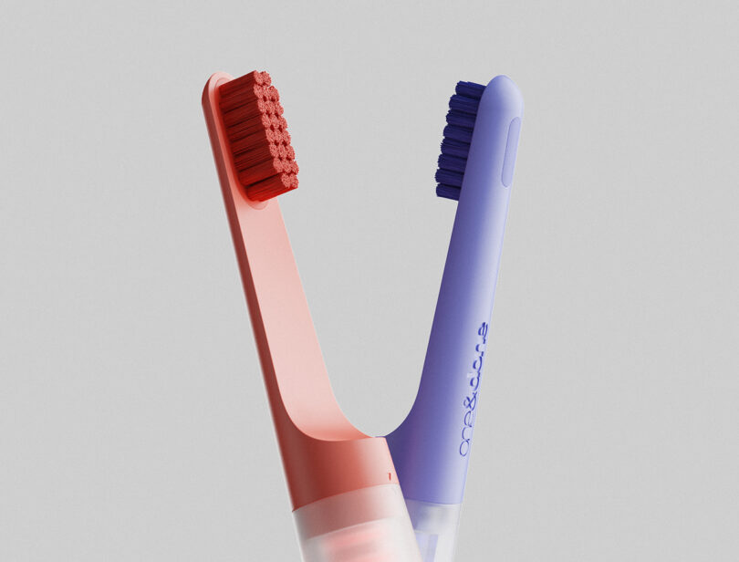 Detail of the coral and blueberry colorways of the one&done toothbrush side by side.