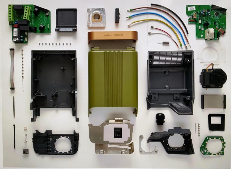 Overhead shot of a completely disassembled Simpson & Partners EV charging system, showing the various internal parts within.